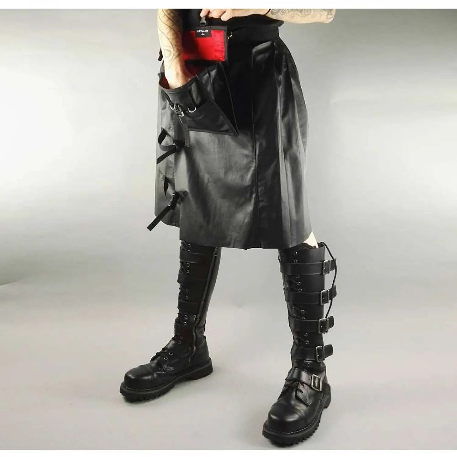 Men's black faux leather kilt with knife pleats and utility pocket detail