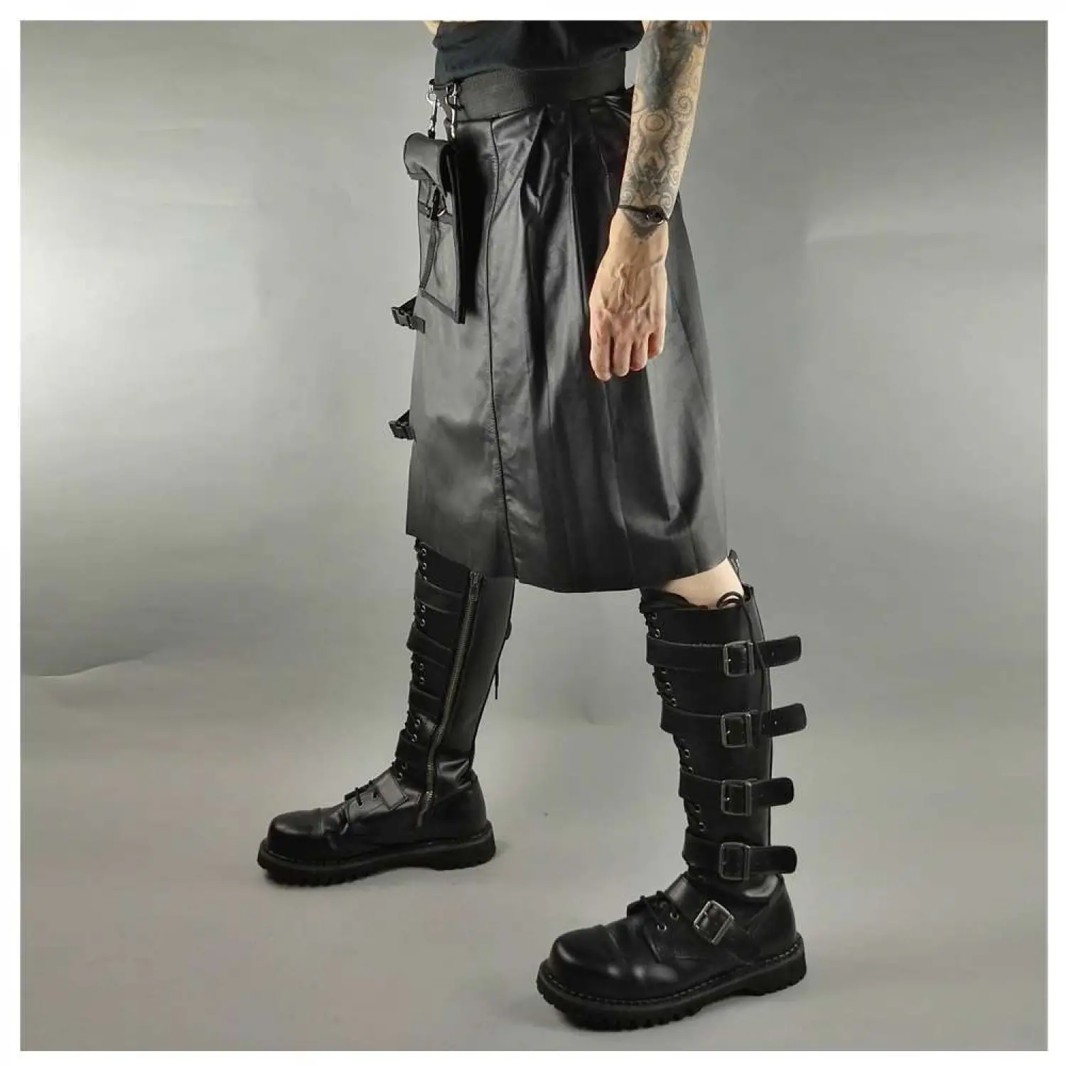Men's black faux leather kilt with knife pleats and utility pocket detail