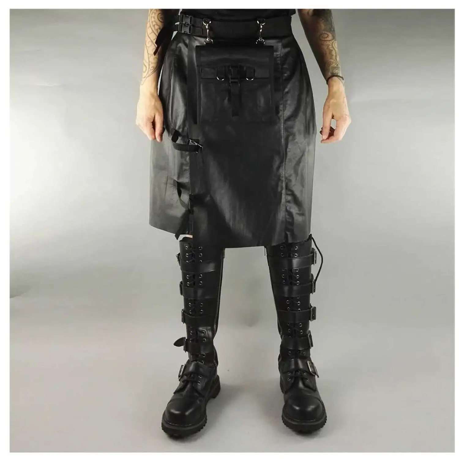 Men's black faux leather kilt with knife pleats and utility pocket detail